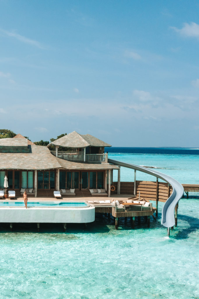 Overwater villa with a waterslide.