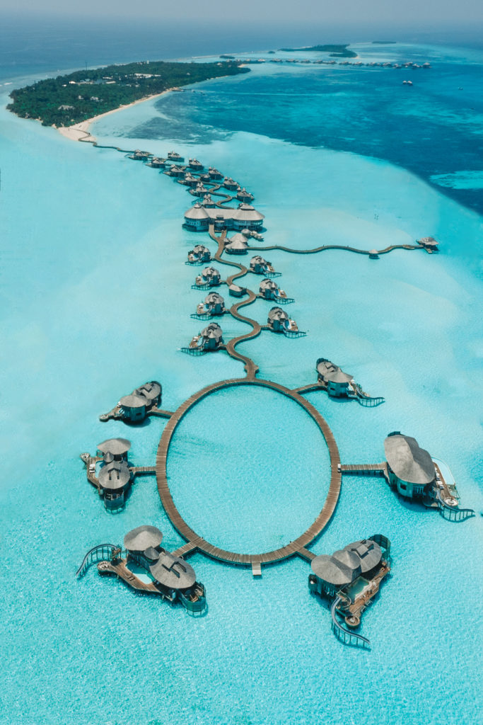 Aerial shot of the Soneva Jani resort, showing water villas and the curved boardwalk.