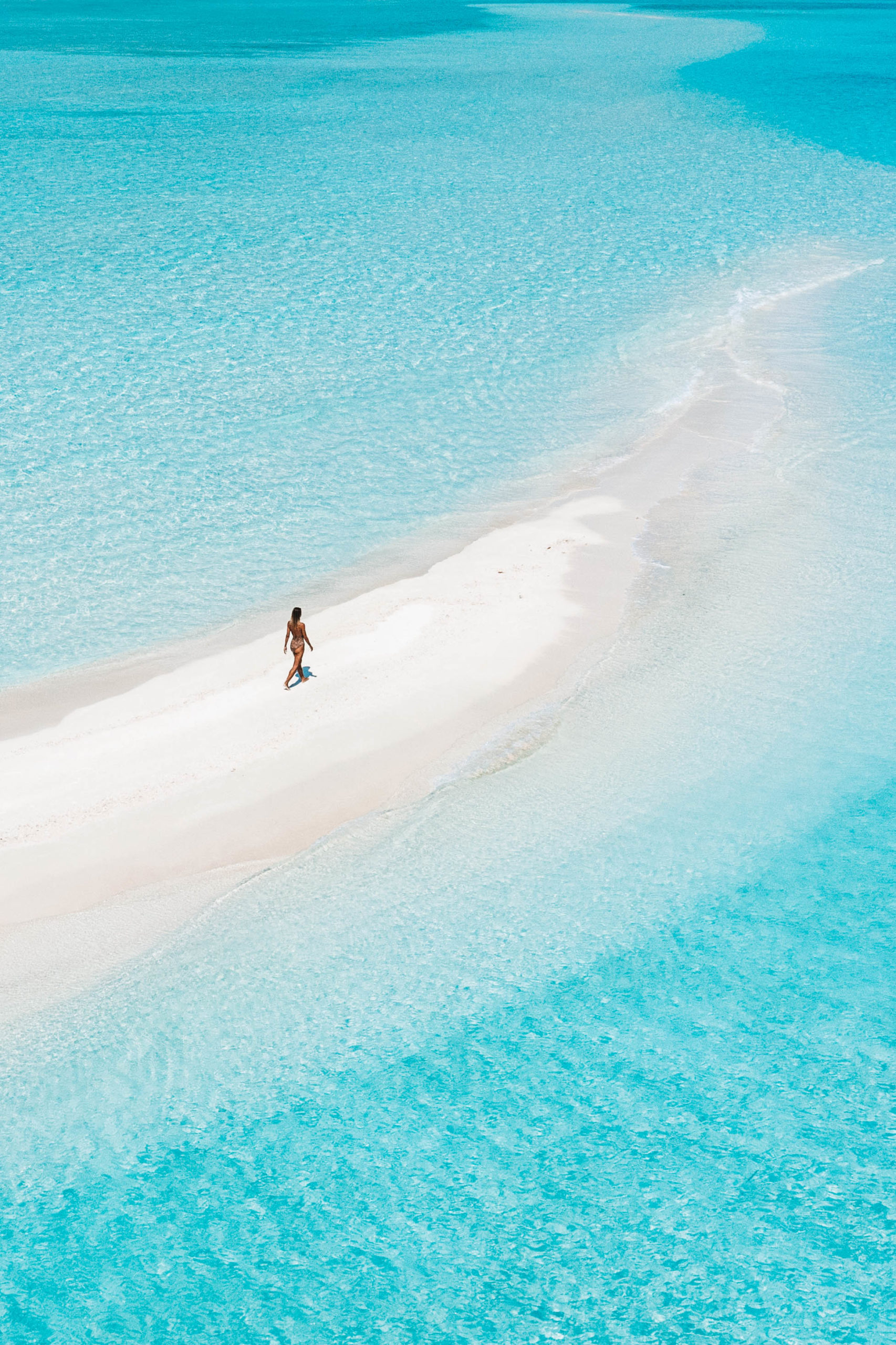 Salty Luxe walking on white sand beach in Maldives