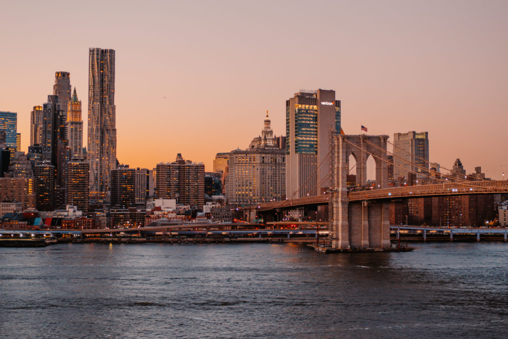 Magical view over Brooklyn Bridge & Manhattan skyline at sunset