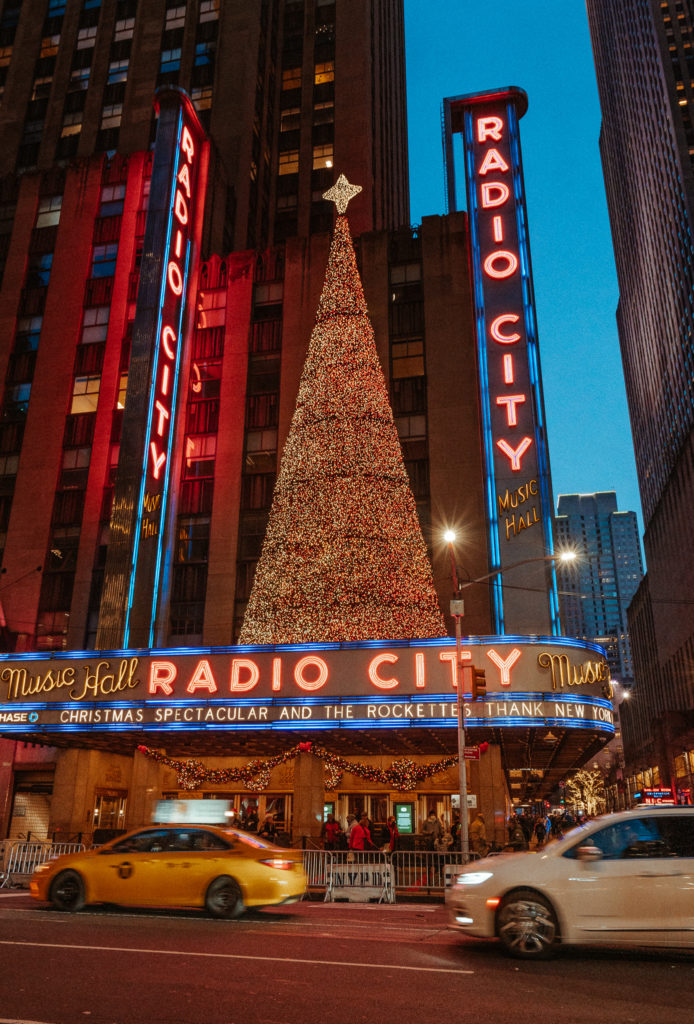 Radio City at dusk. Including beautiful, ambient lighting, it's iconic 'RADIO CITY' city & a Christmas tree to mark the festive season.