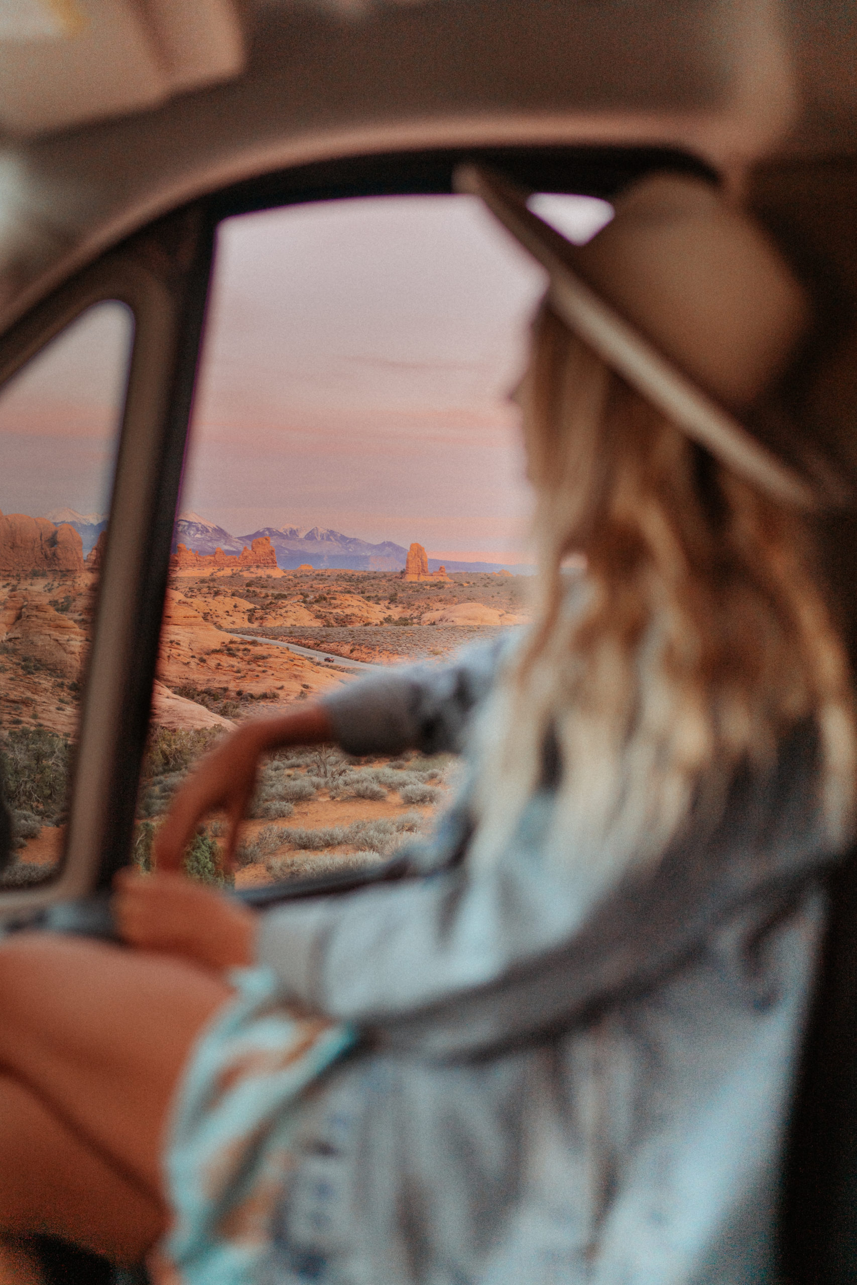 Sarah looking out car window in Arches National Park