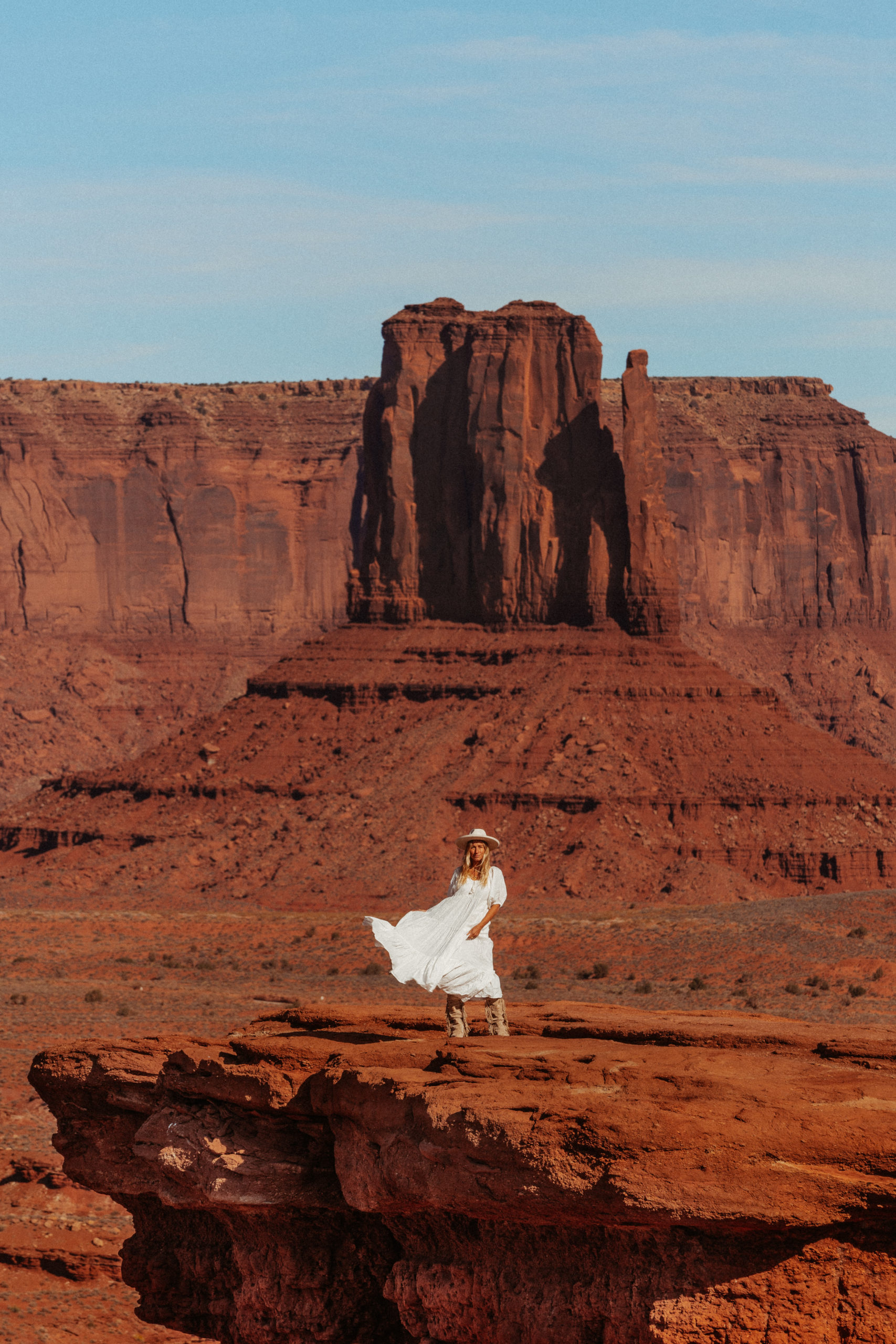 Sarah swishing her white dress in Monument Valley
