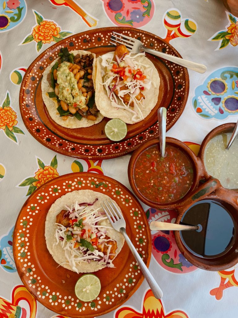 Colourful mexican plates with tacos and sauces