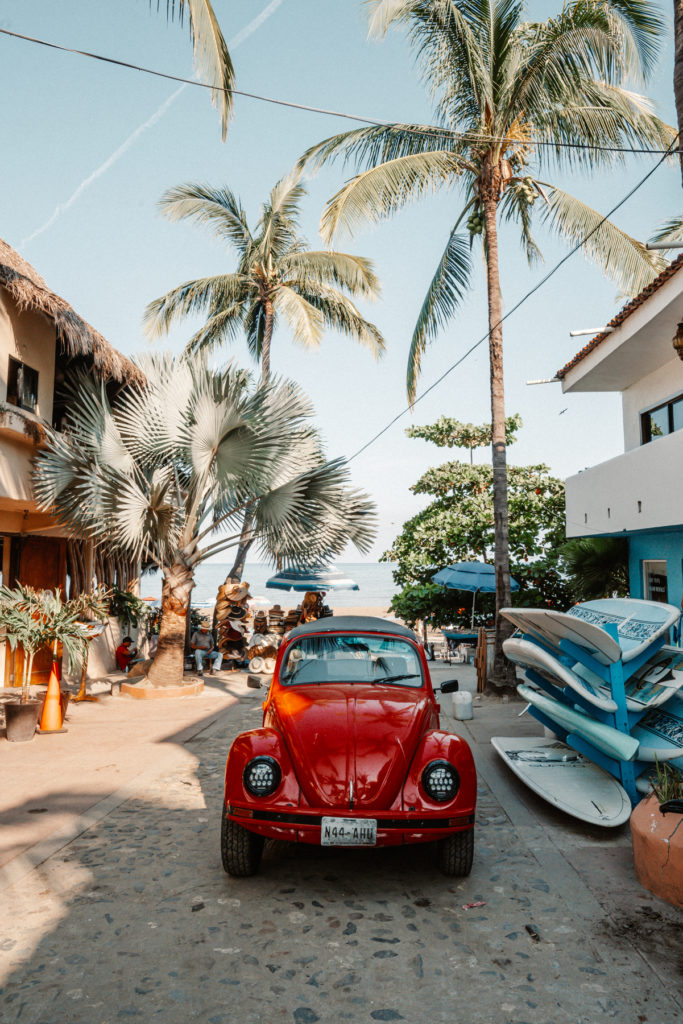 Red Volkswagon Beetle parked in a street in Sayulita town.