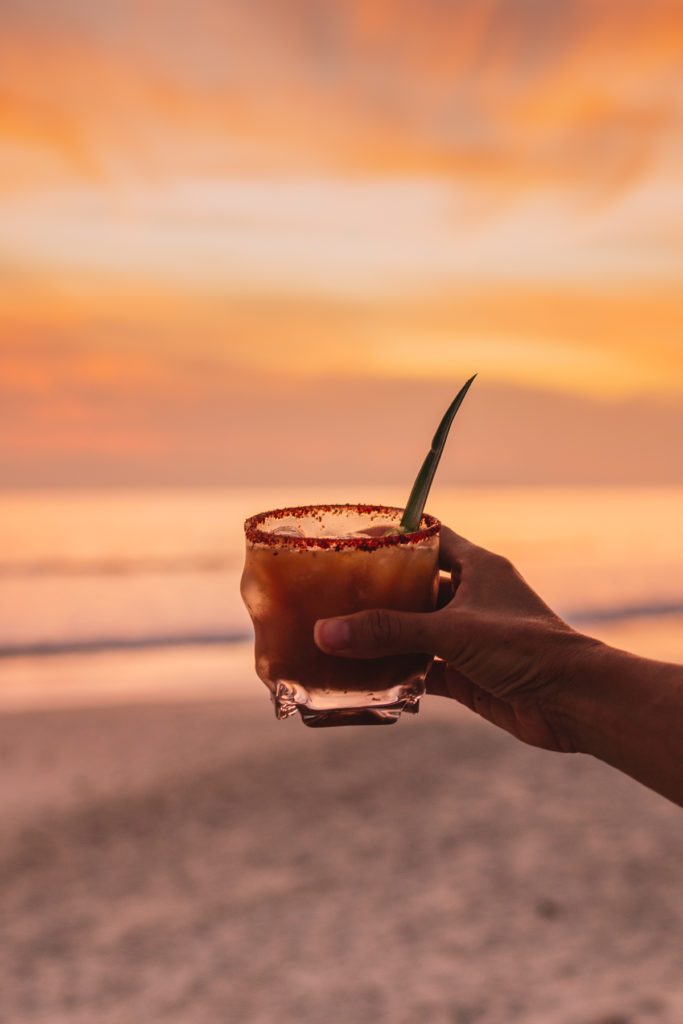 Woman holding a Spicy Margarita at sunset