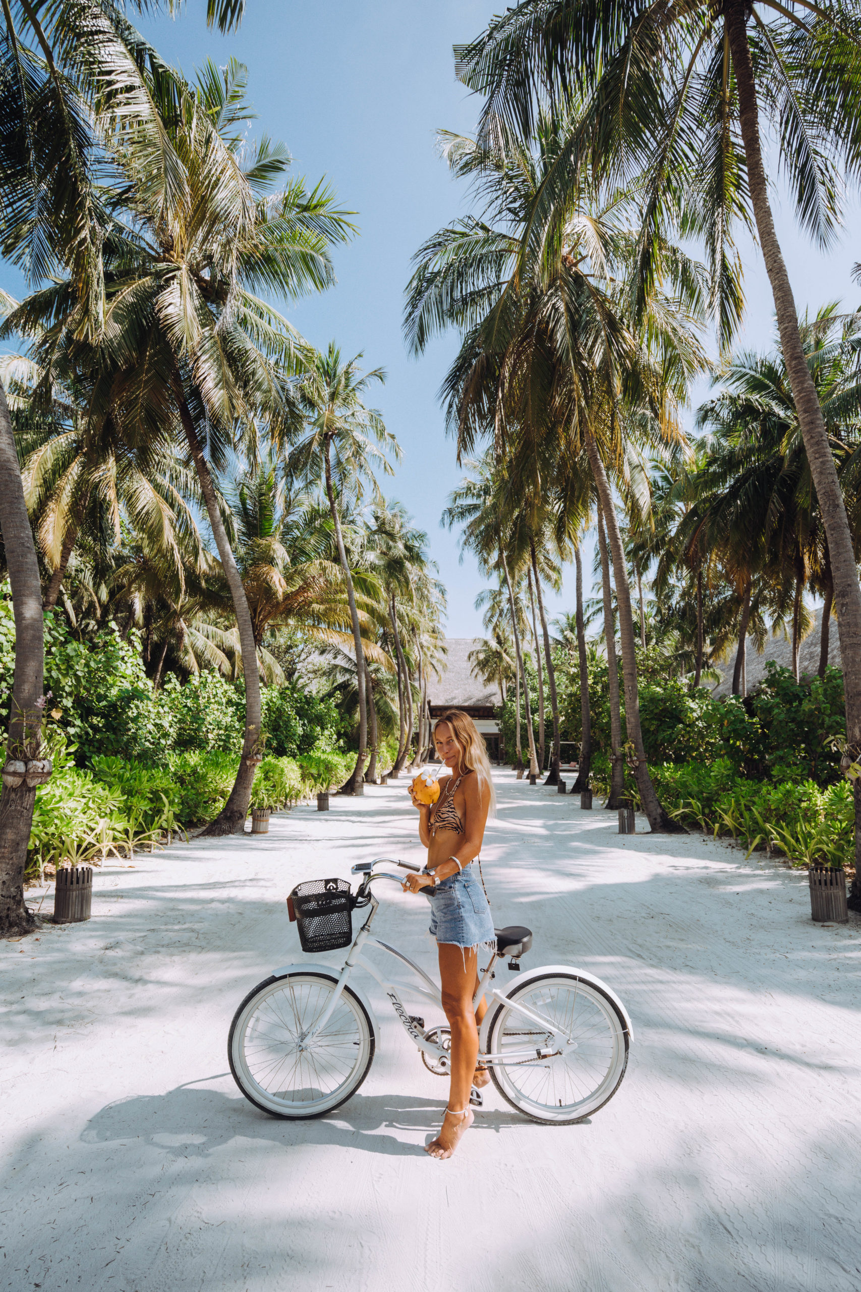 Sarah drinking coconut on bike
