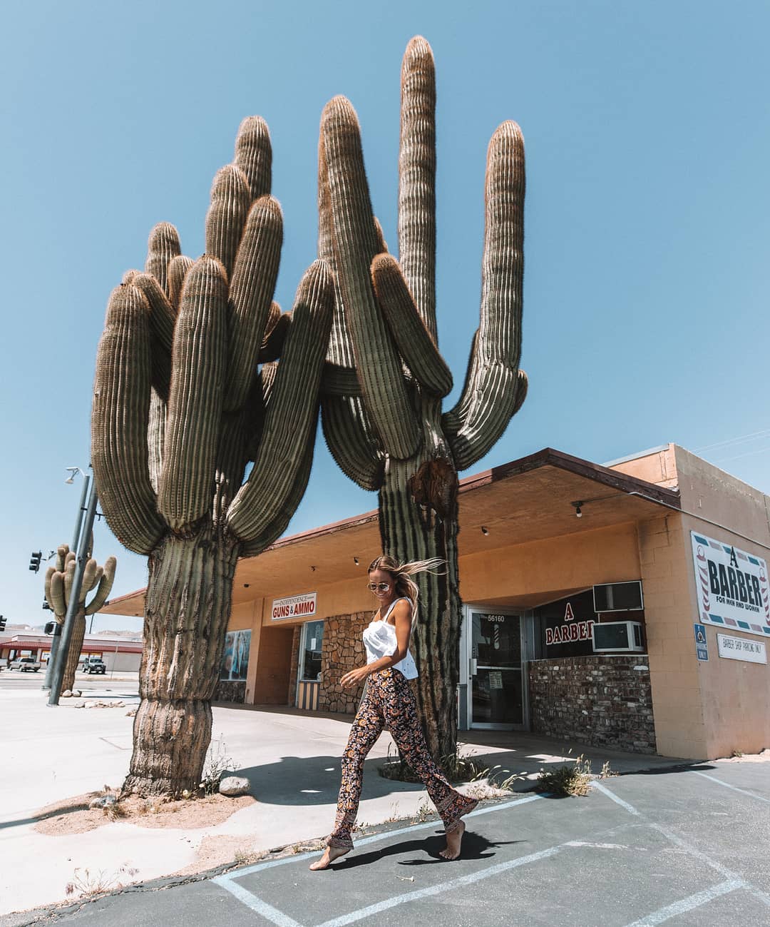 Sarah walking in front of a barber in Yucca Valley
