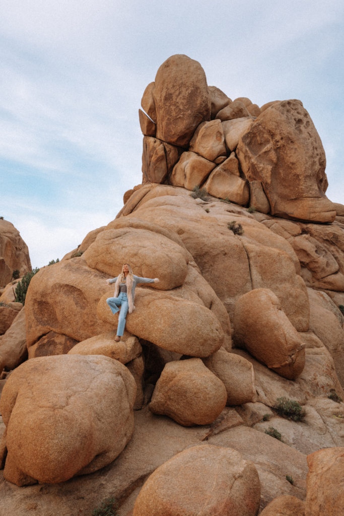 Sarah climbing boulders in Joshua Tree National Park