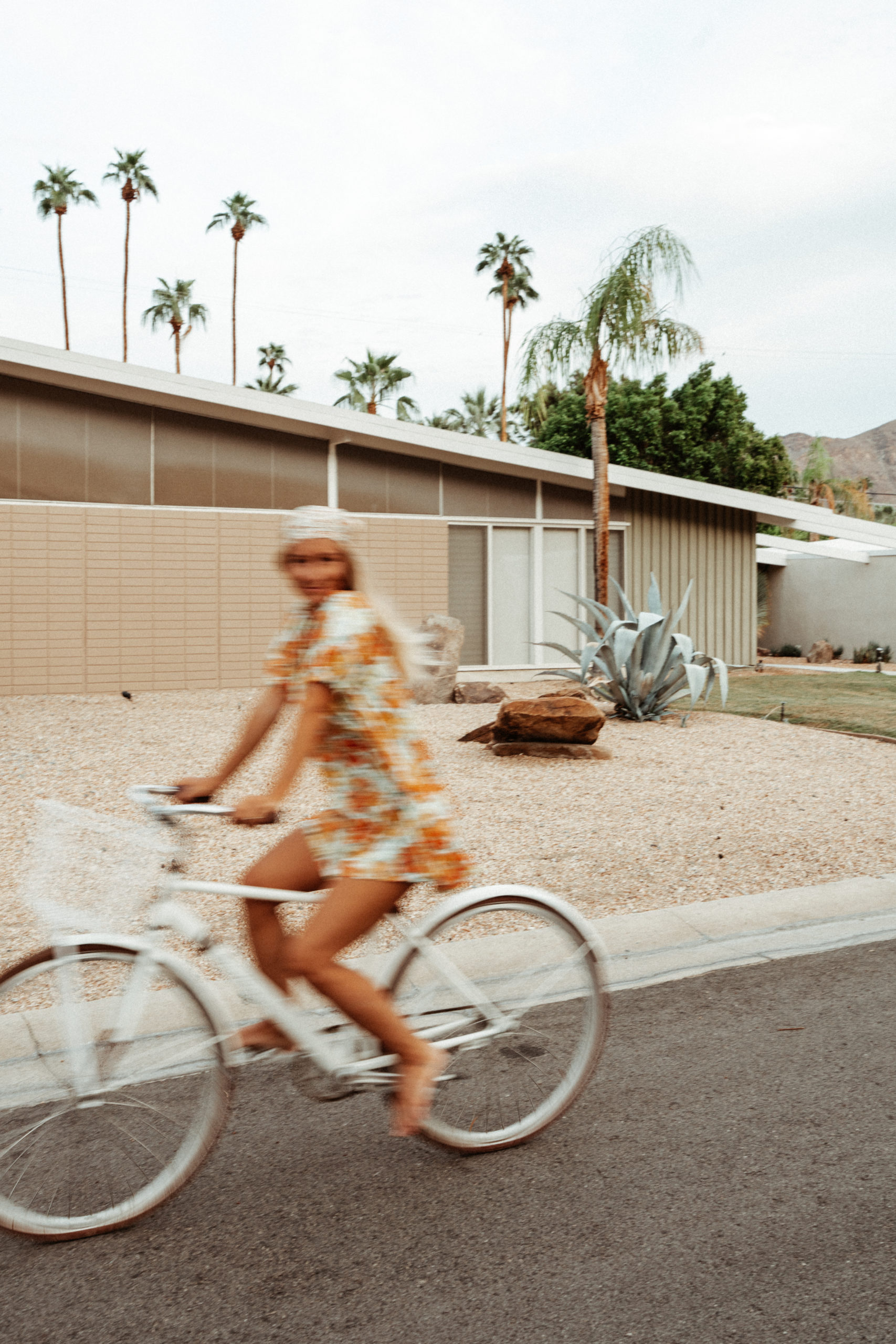 Blurred shot of Sarah riding her bike in Palm Springs Indian Canyons neighbourhood
