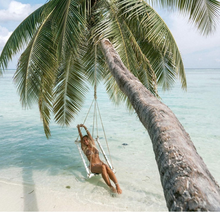 Sarah in a hammock under a palm tree