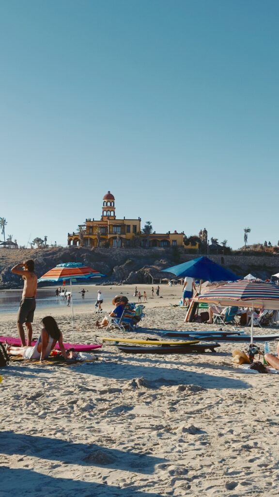 Cerritos Beach - beach goers sitting on beach chairs and walking on the beach.