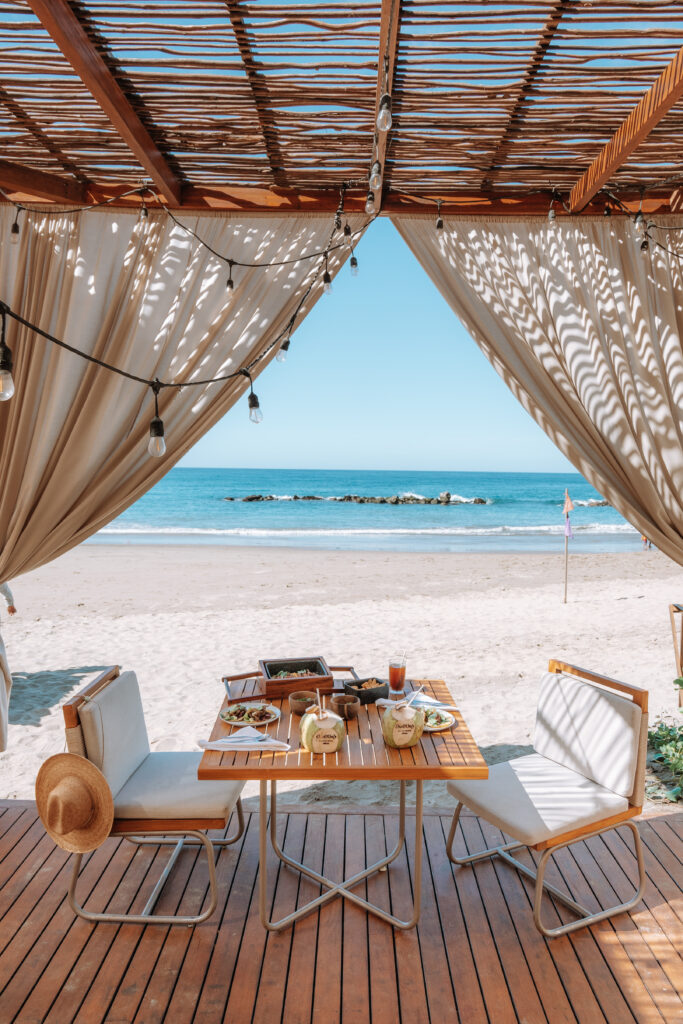 Lunch on a table, in a cabana by the beach.