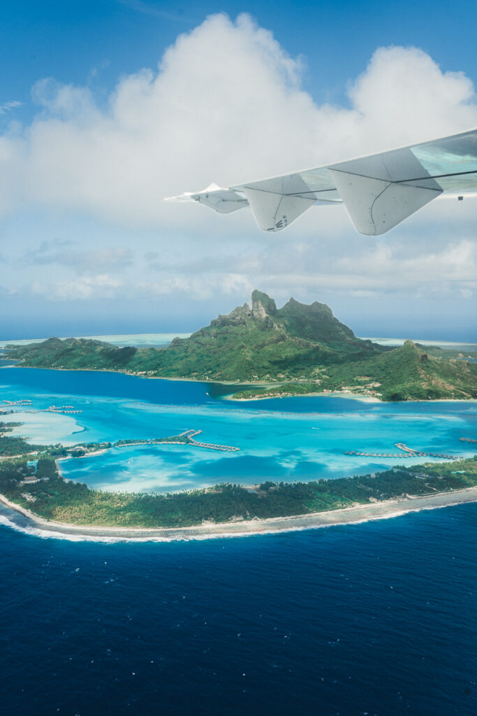 View of Bora Bora from the plane, showing the main island and mountain, as well as the fringing islands.