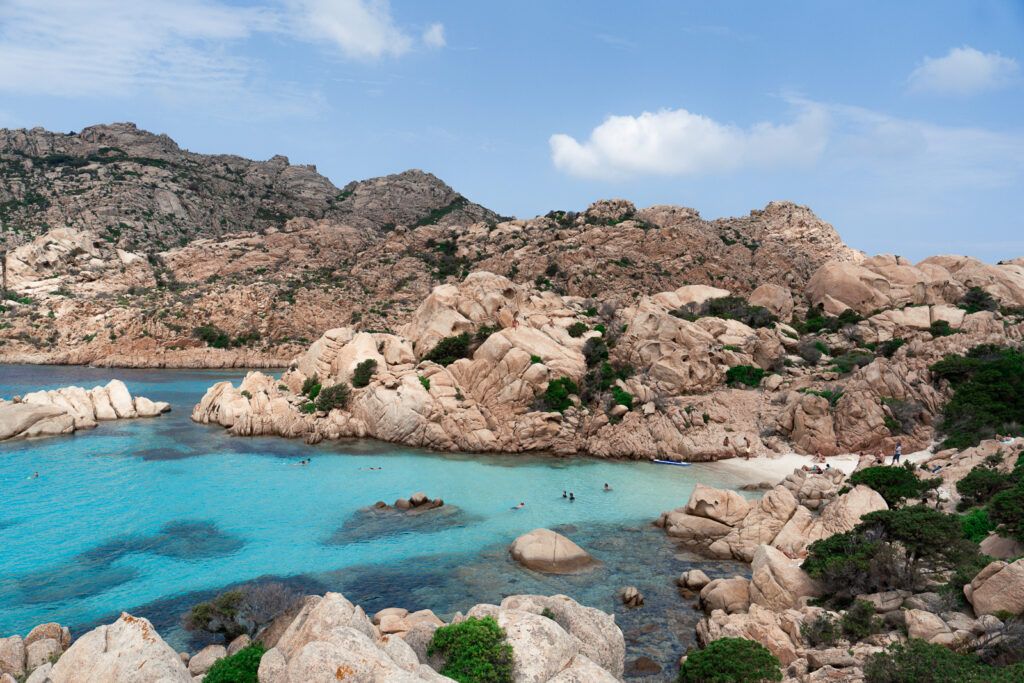 Small beach surrounded by rocky coastline in Sardinia 