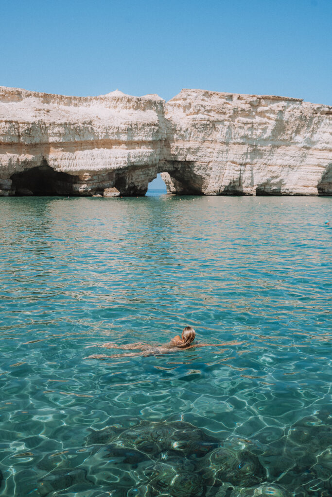 woman swimming near Daymaniyat Islands in Oman
