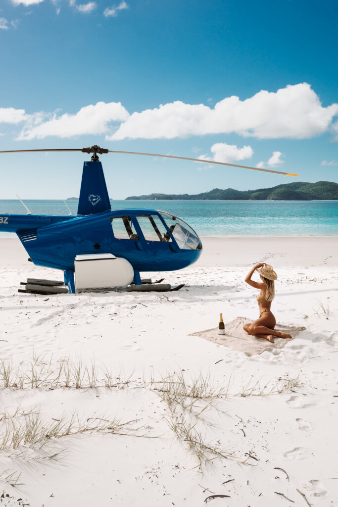Salty Luxe with helicopter on the beach in the Whitsundays