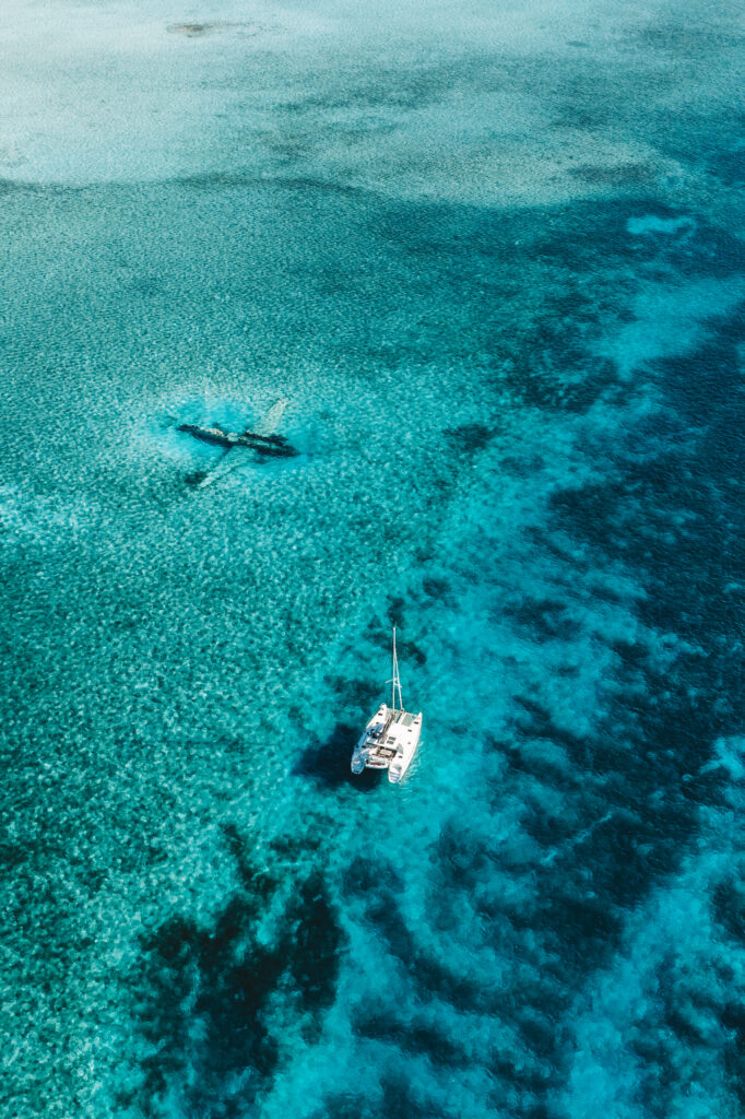 Staniel Cay plane wreck with catamaran in Exumas Bahamas, one of the top tropical destinations to visit