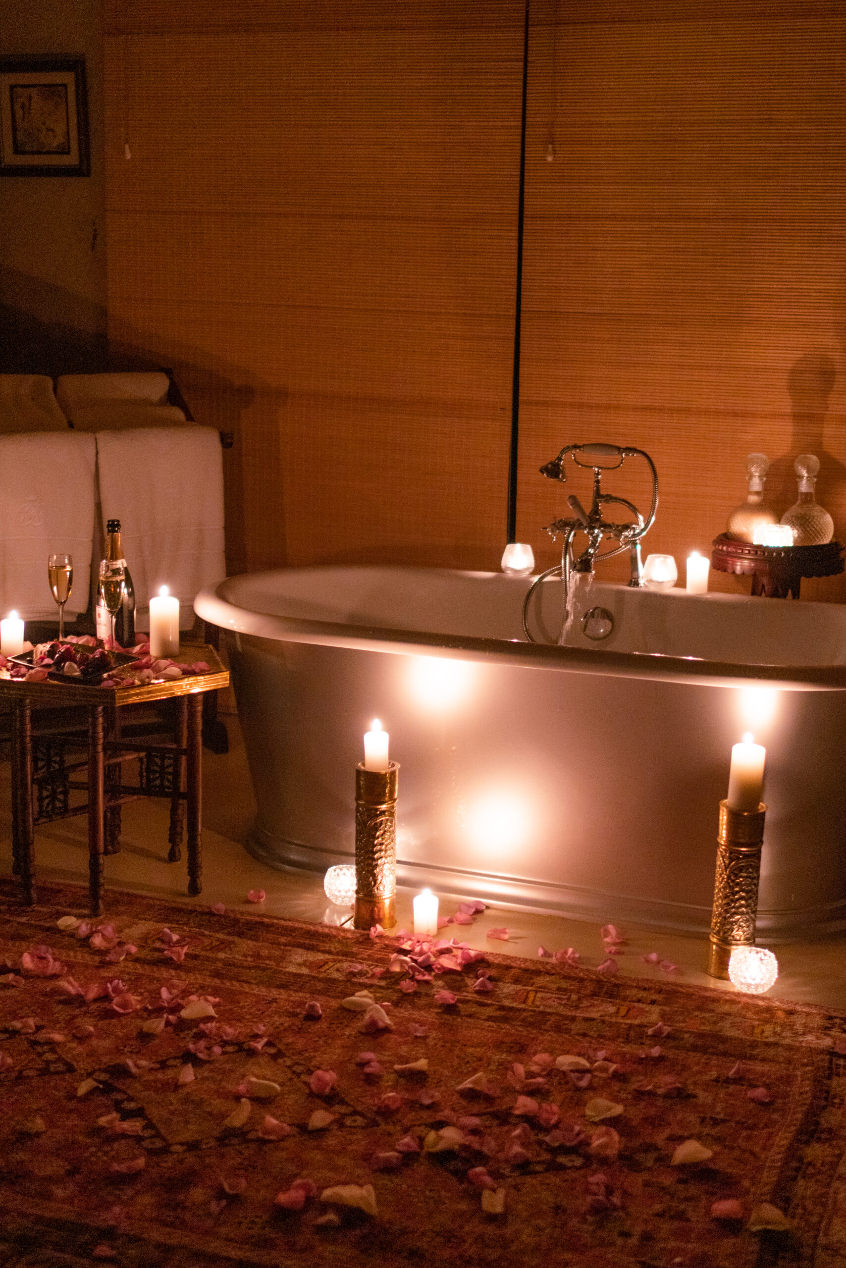 empty bathtub surrounded by candles at malewane lodge