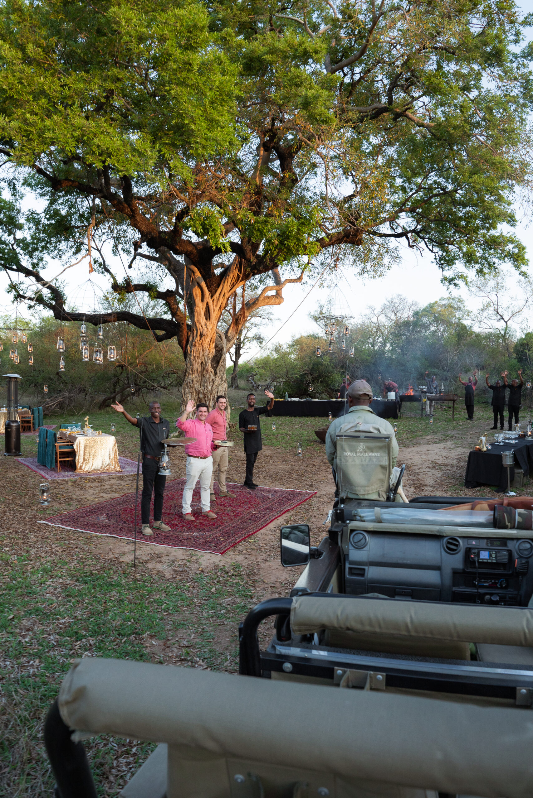 the staff at royal malewane waving at the safari vehicle as it drives by