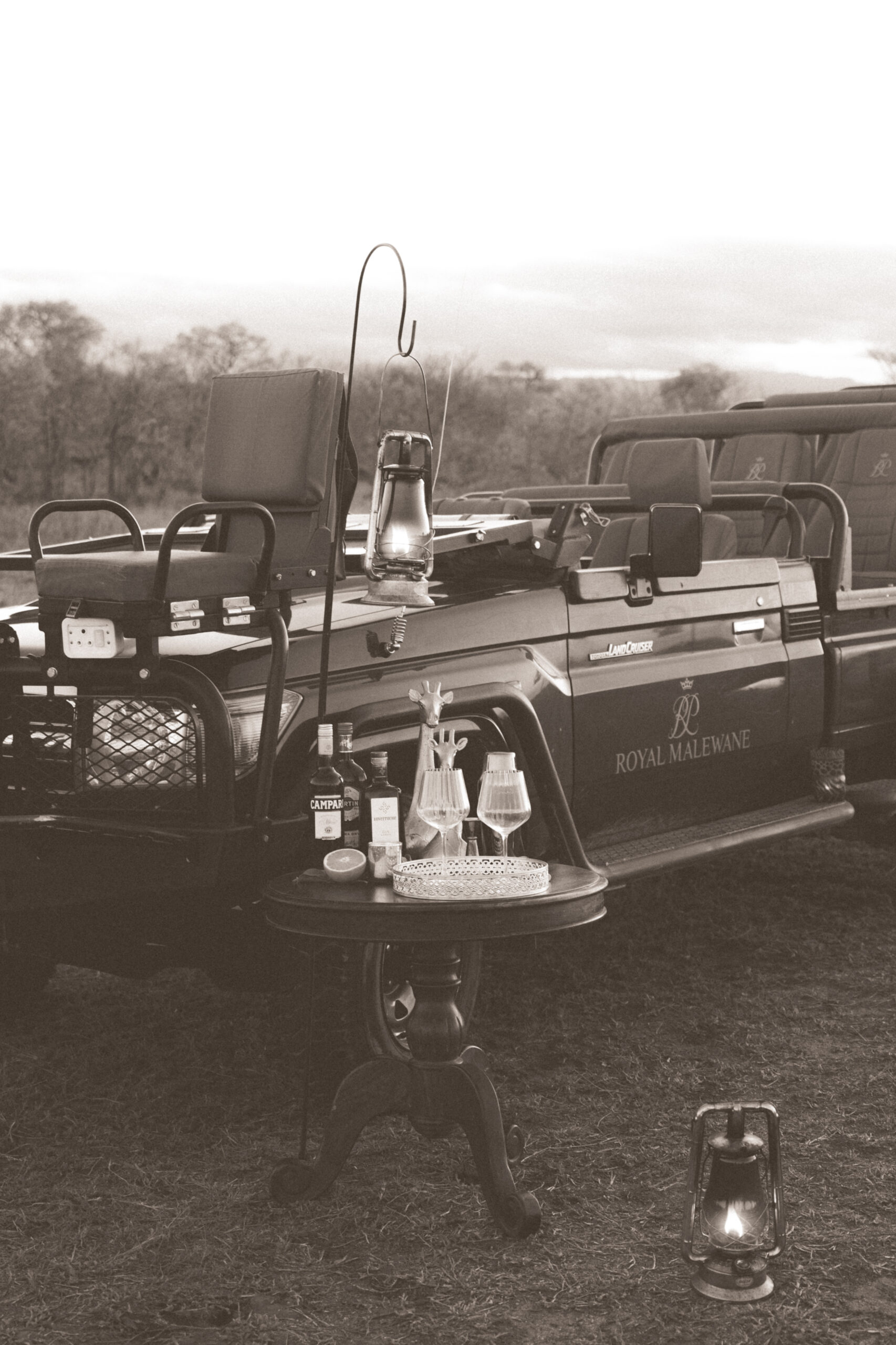 black and white photo of royal malewane safari vehicle with wine for sunset drinks in kruger national park