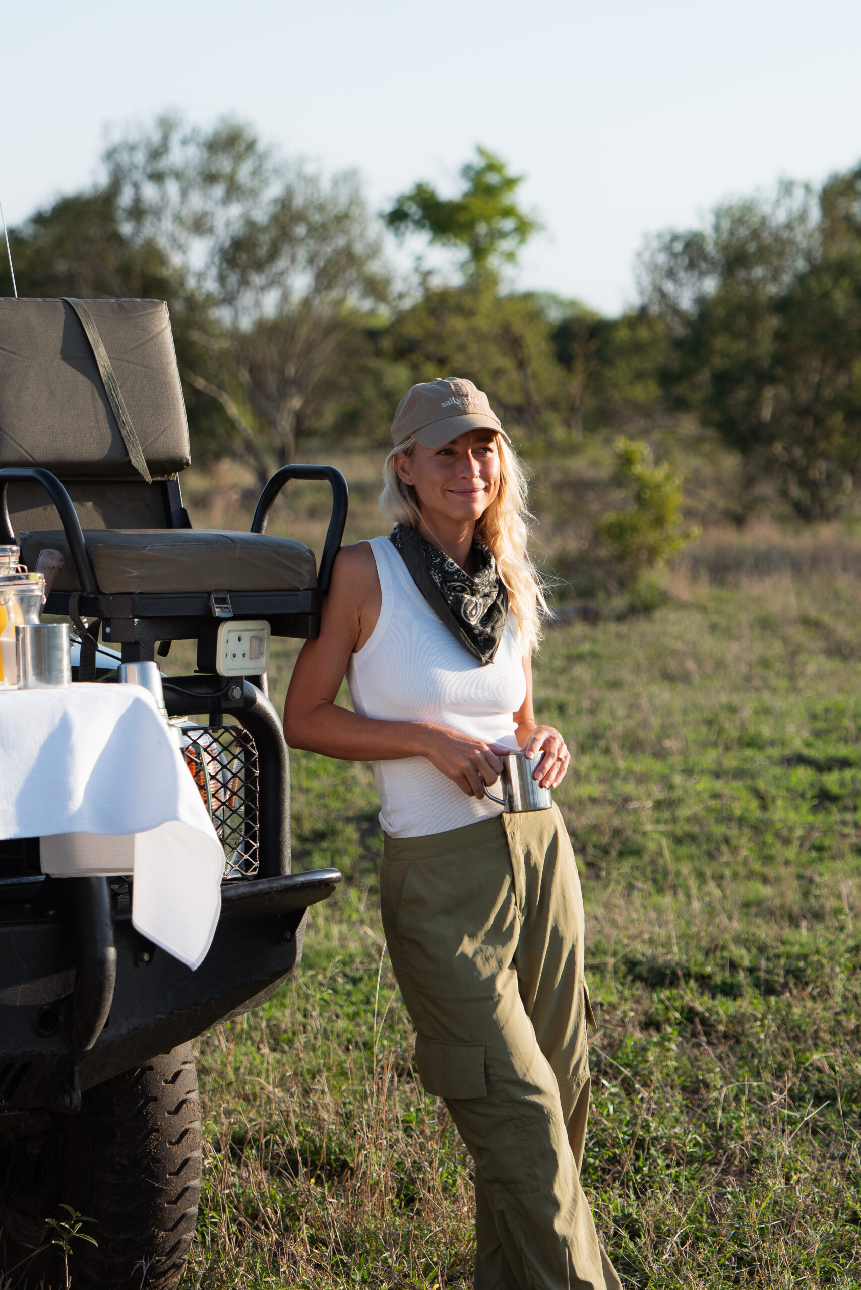 salty luxe leaning on a safari vehicle