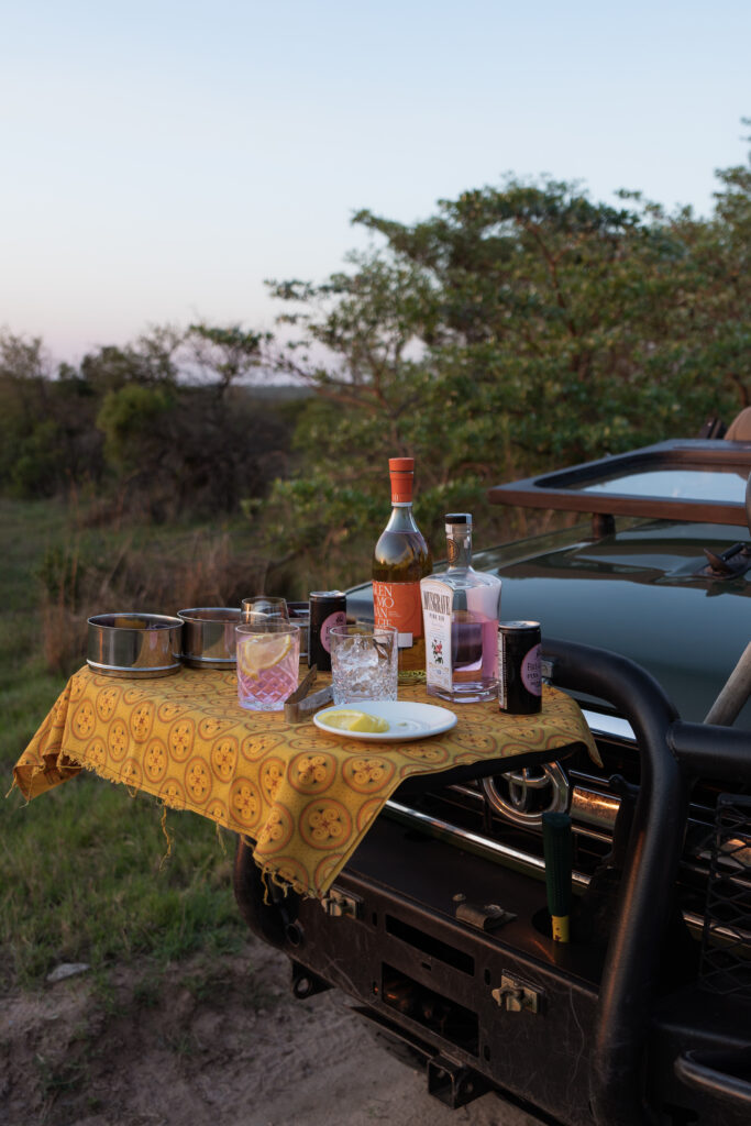 sunset drinks set up on the front of a royal malewane land rover safari vehicle