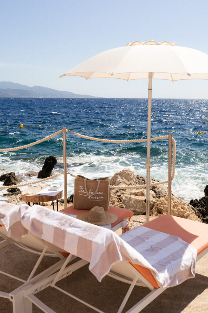 beach loungers and umbrella at maybourne la plage