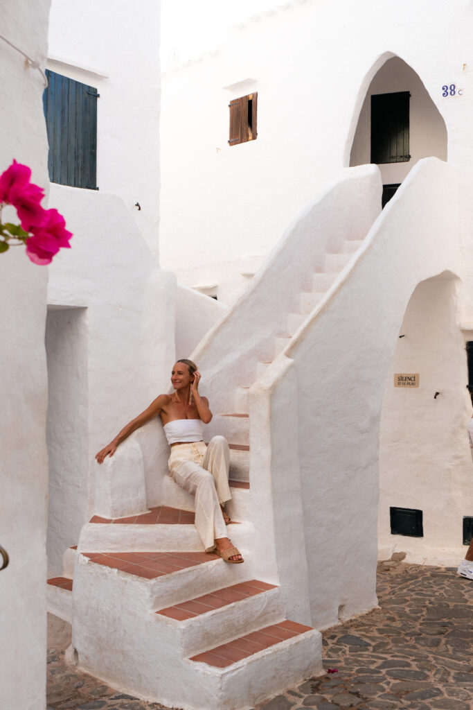 Salty Luxe sitting on the stairs in Binibecca Menorca