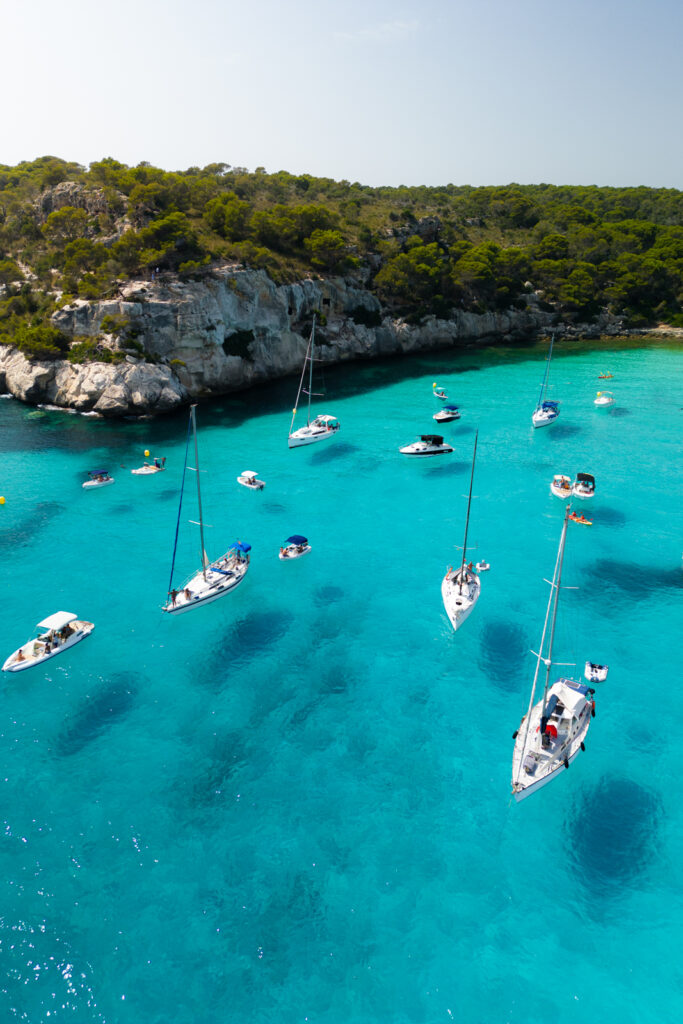 Boats in the clear water of Cala Macarelleta