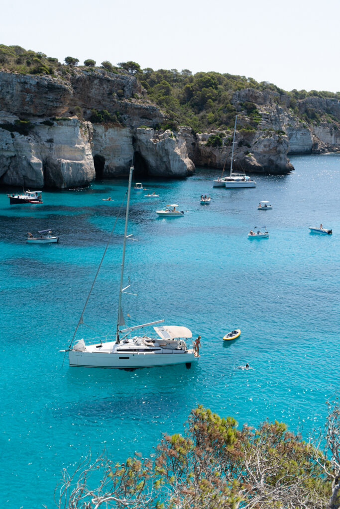 A variety of boats in the water at Cala Macarelleta Menorca