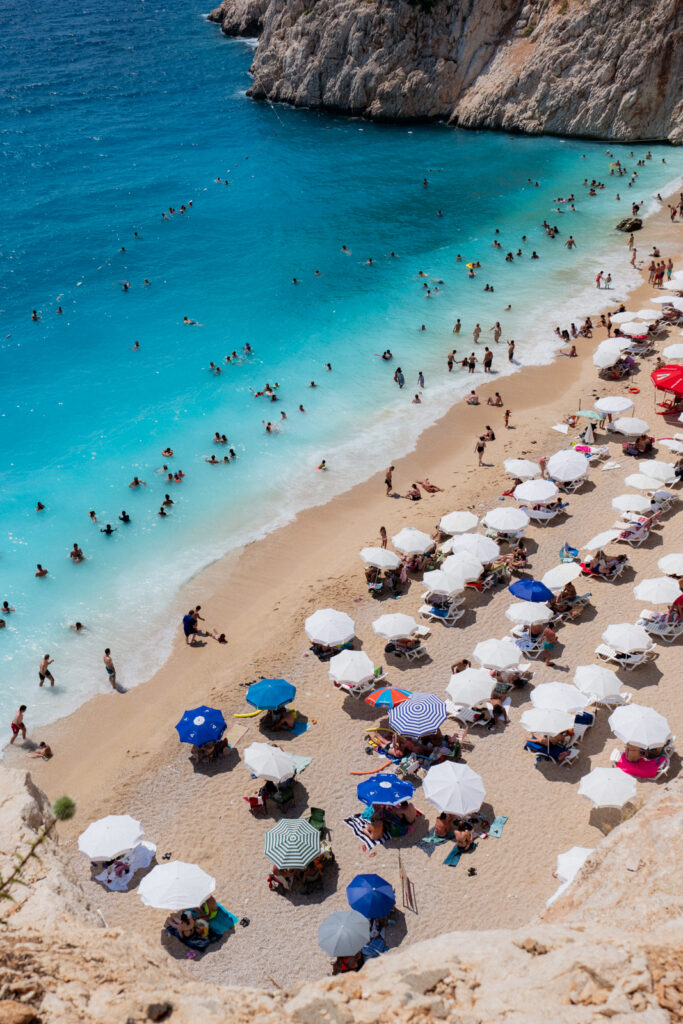 looking down on the colorful umbrellas and turquoise waters of kaputas beach in turkey