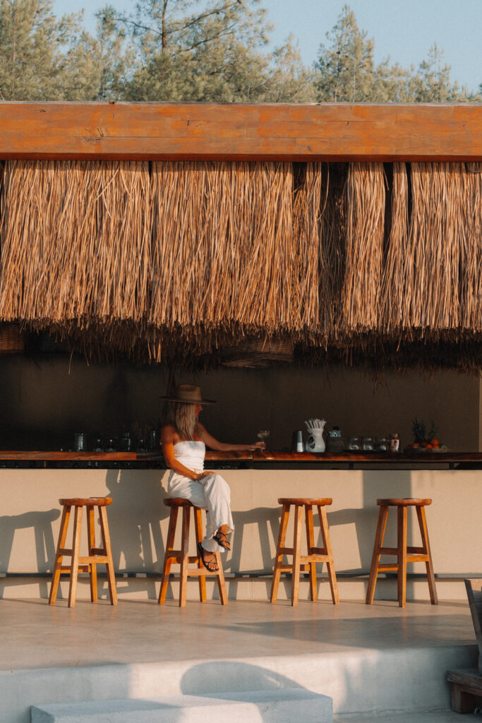 woman sitting at the bar at Six Senses Kaplankaya