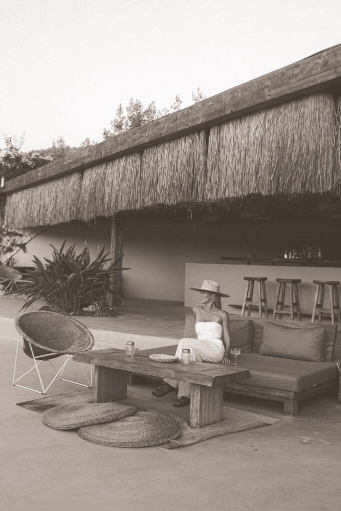 black and white photo of salty luxe sitting on a couch at the bar at Six Senses Kaplankaya