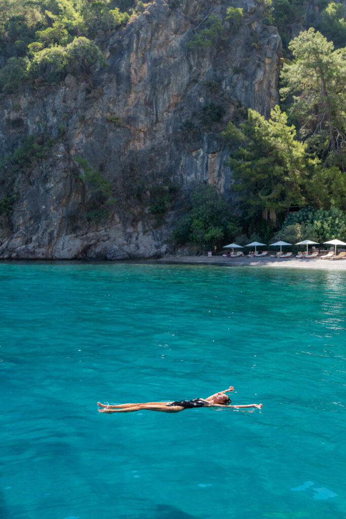 woman floating in the water at yazz collective fethiye