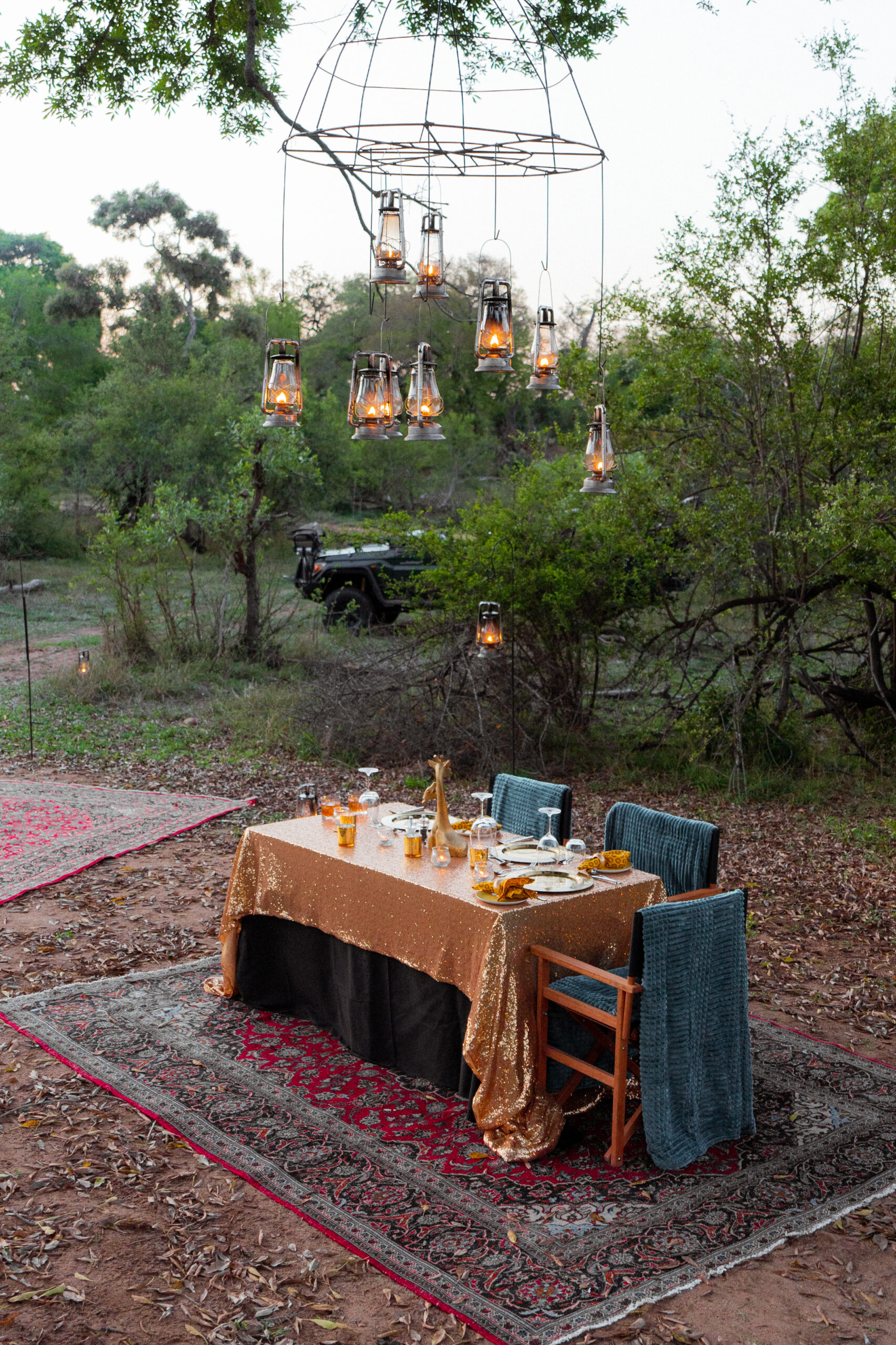 Sunset in the bush dinner with Royal Malewane showing the dinner table and lanterns