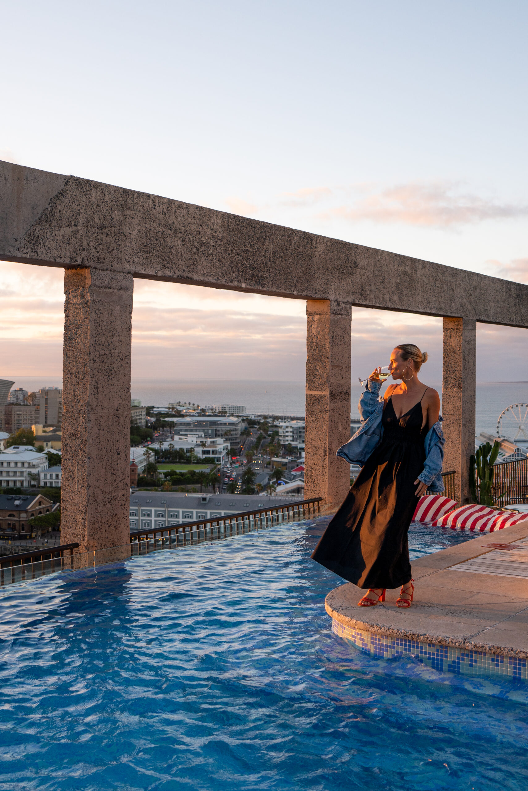 salty luxe drinking a glass of wine by the pool at the silo hotel cape town on a 10 day south africa itinerary