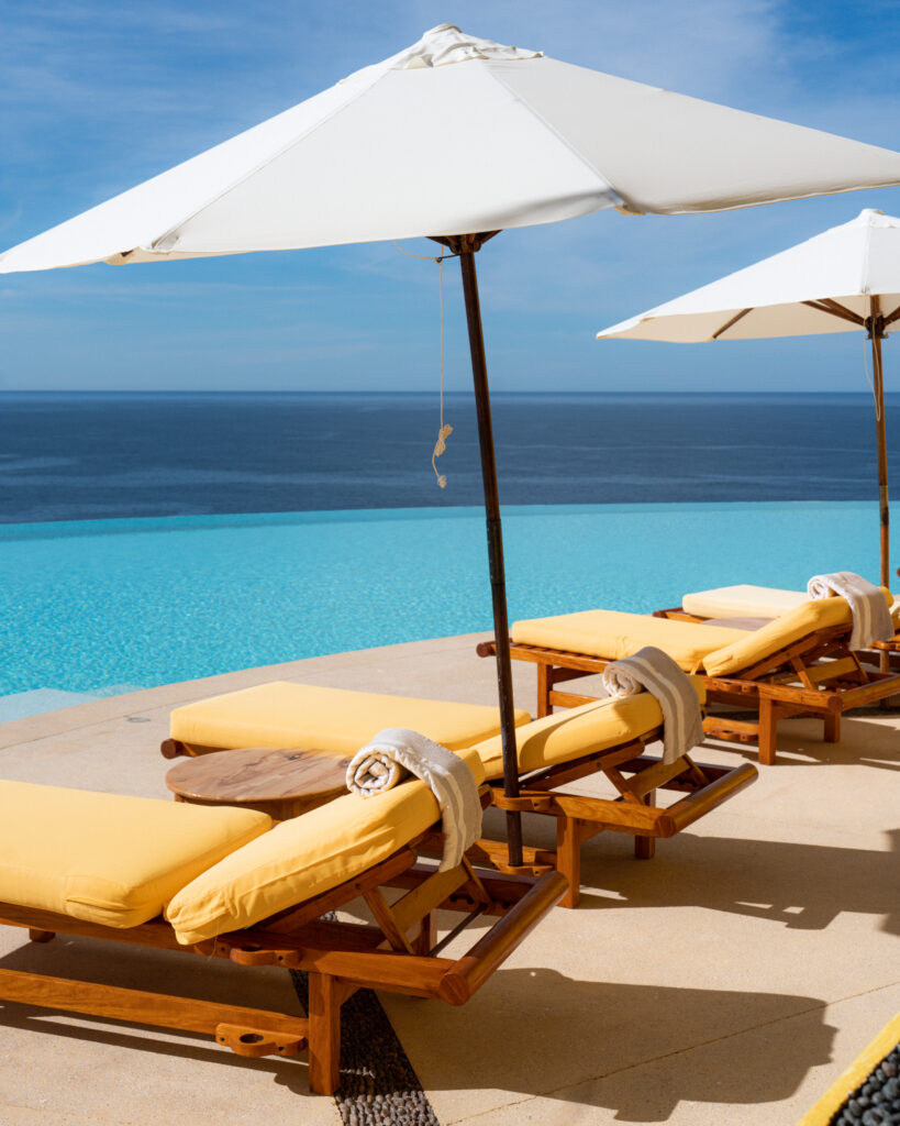 lounge chairs overlooking the pool and ocean at careyes on the pacific coast of mexico