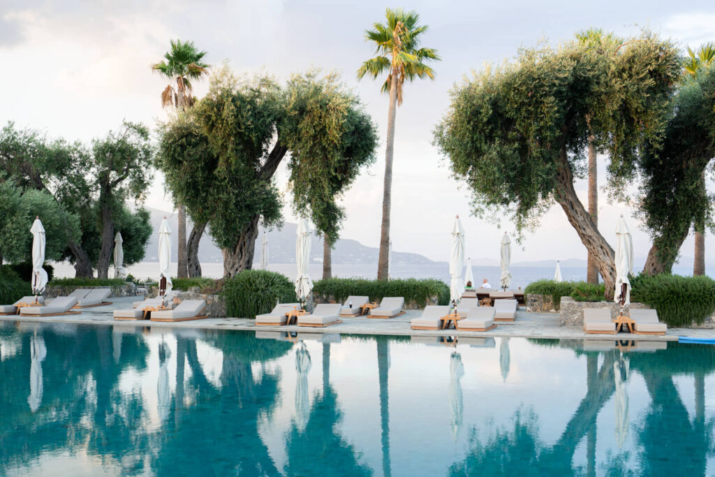 lounge chairs and pool at Grecotel Corfu Imperial