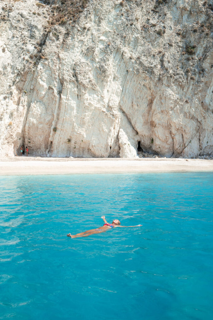 salty luxe floating in the water at paradise beach on the Greek island of Corfu