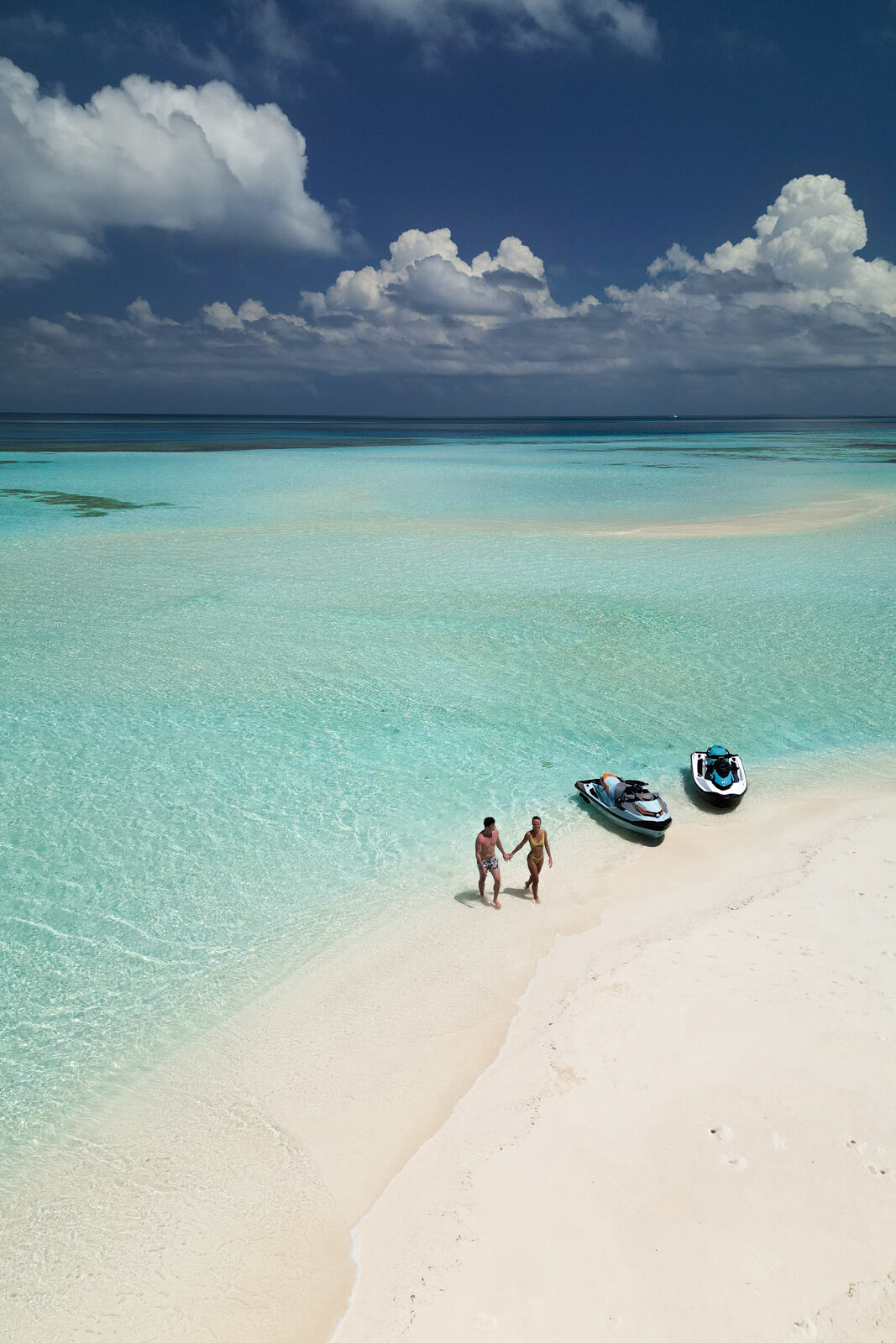 A couple with jet skis at Jawakara Maldives on a sand bar