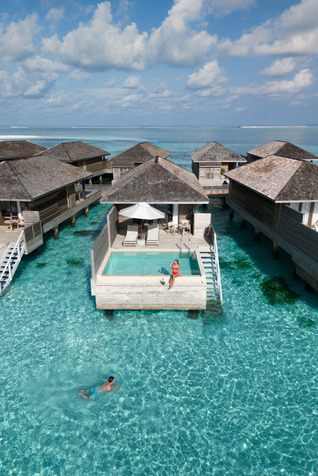 Sitting on the edge of the private pool overwater bungalow at Jawakara Maldives